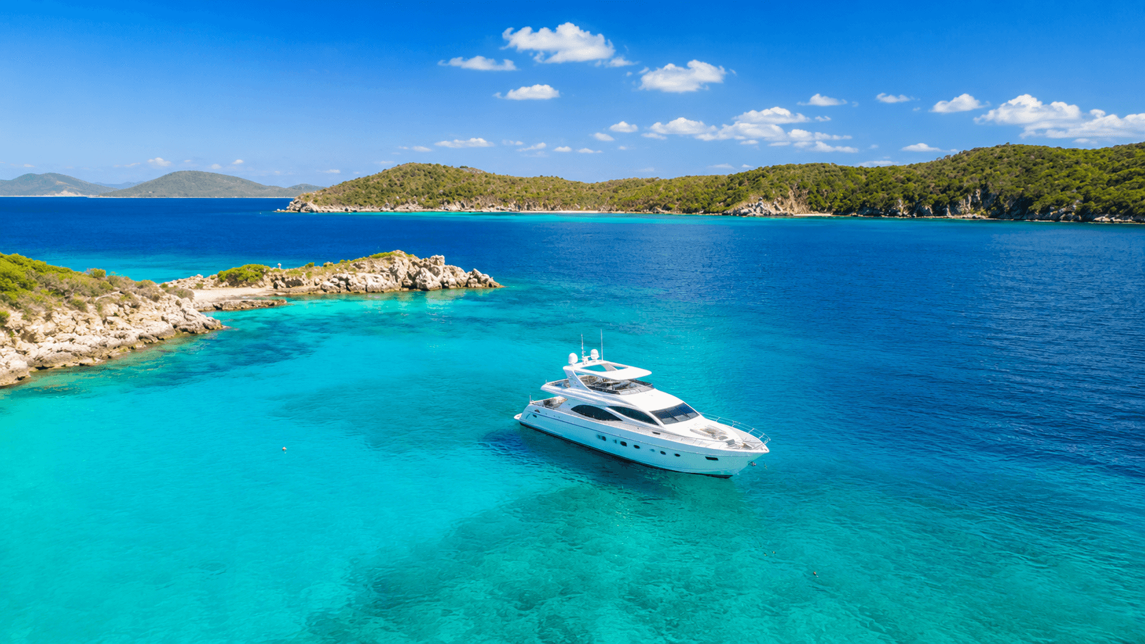 A private island in the North Sound off Virgin Gorda at dusk, yachts at anchor, British Virgin Islands.