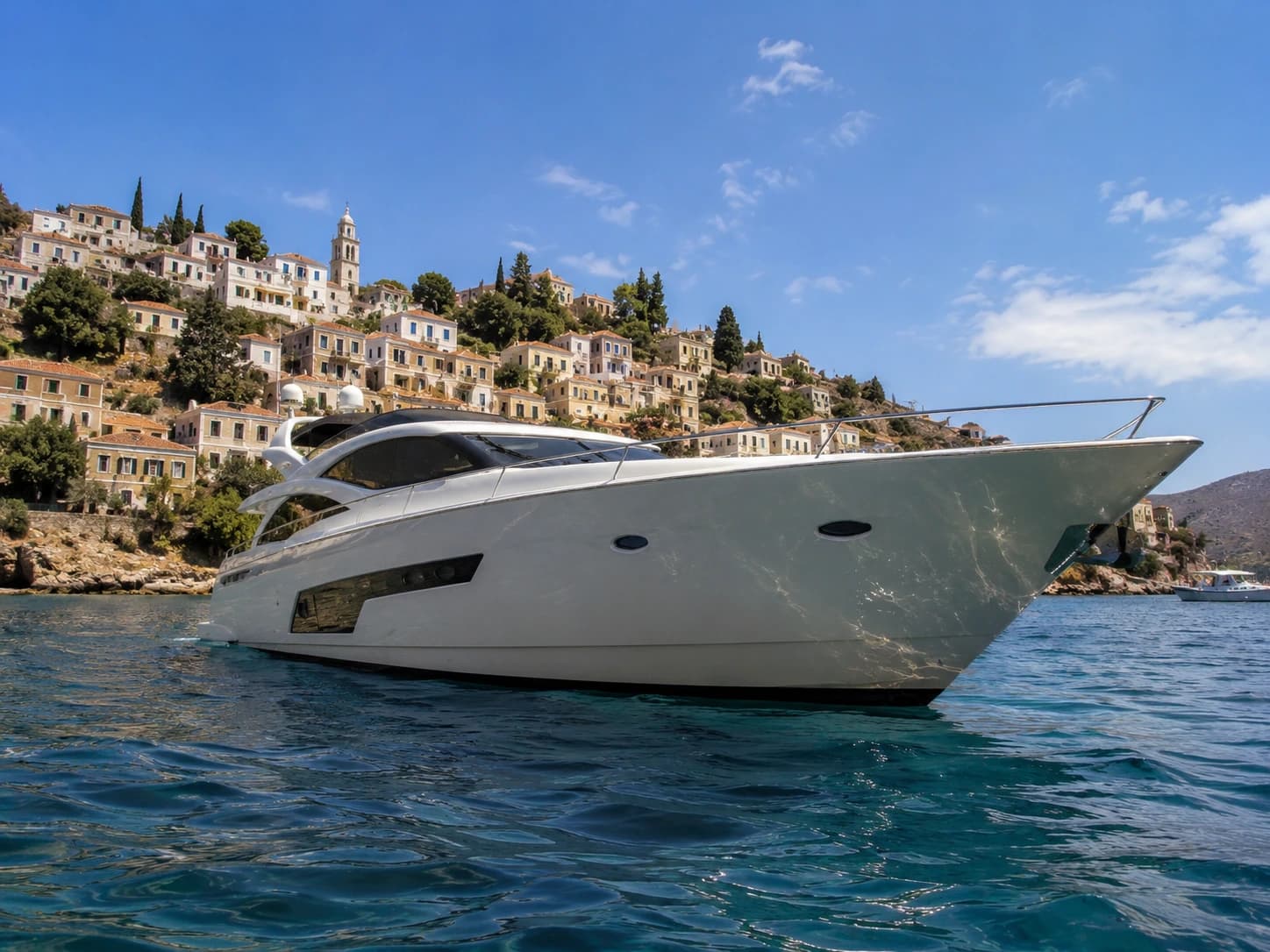 Crewed yacht anchored off a quiet Cyclades island