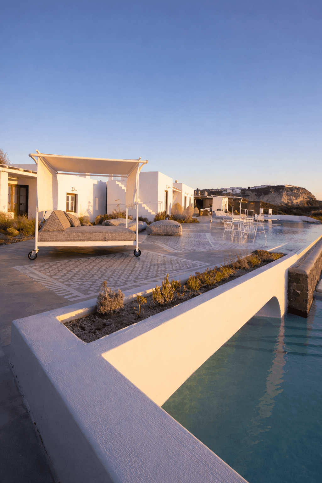 Palm-lined luxury resort landscape at dusk.